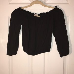 Black off the shoulder sleeved crop top.