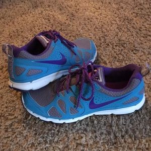 Teal and purple NIKE trail running shoes