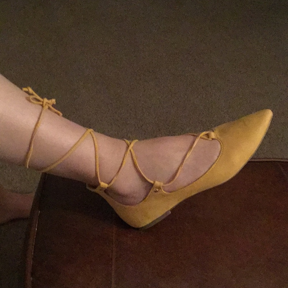 Suede mustard pointed toe lace up flats.