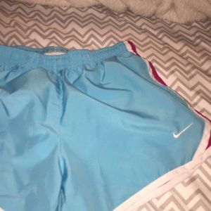 Girls teal and purple Nike shorts.