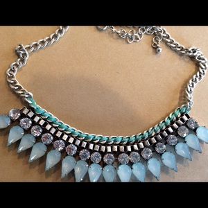 Statement necklace with stone and metal details.
