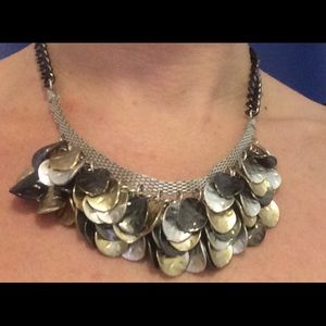 Statement necklace in silver and gold design.