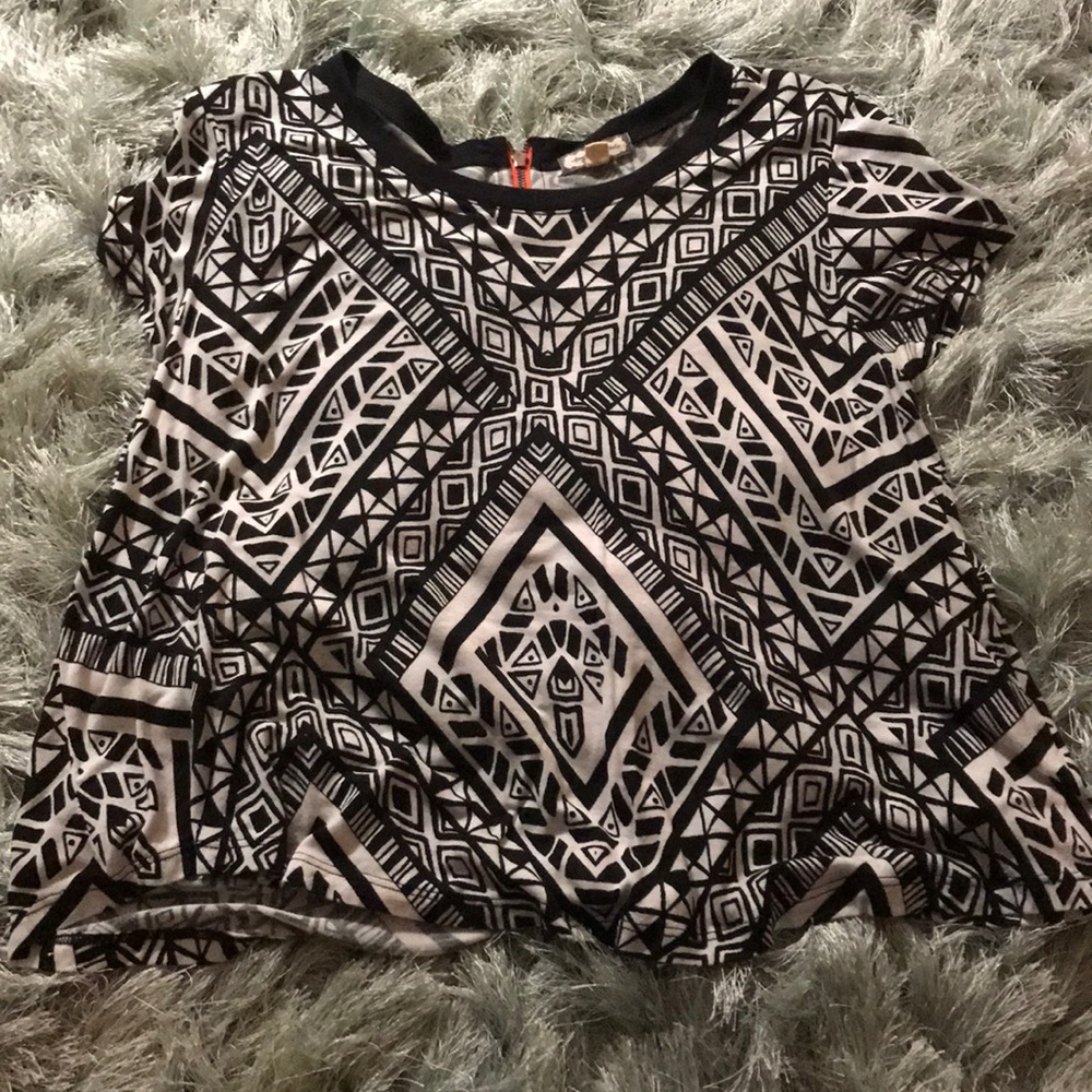 Aztec black and white top with orange zipper.