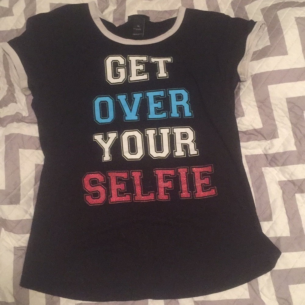 Black shirt with words “get over your self”