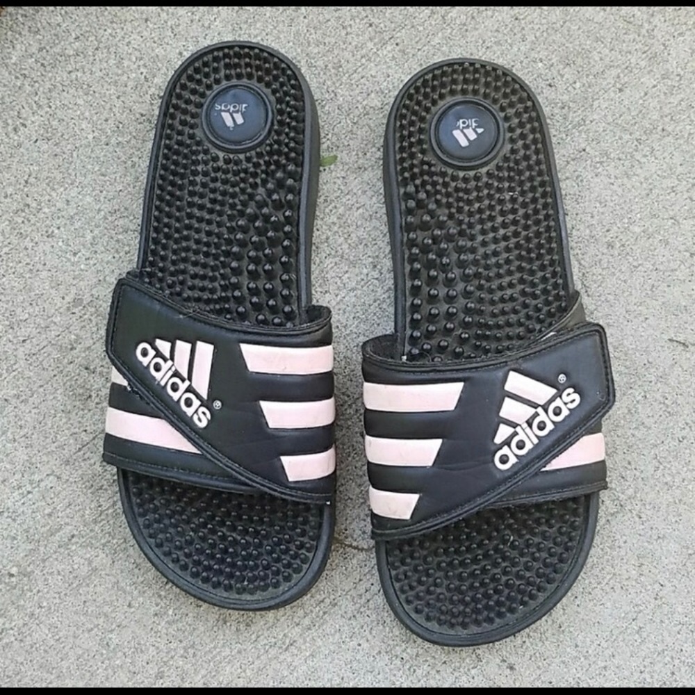 Pink and black adidas flip flops