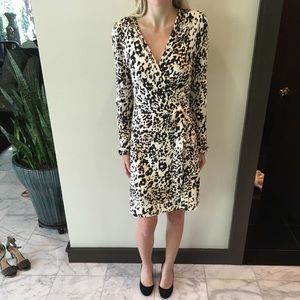 Long-sleeve, low cut, wrap dress.