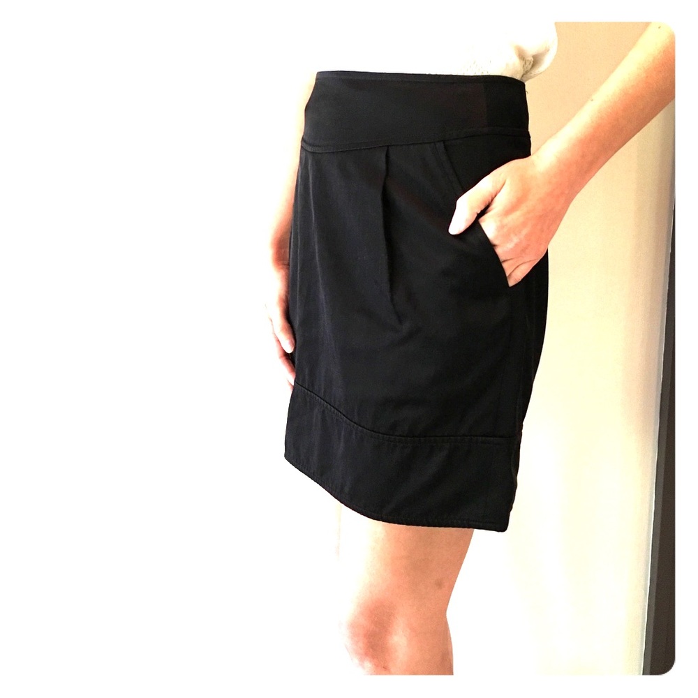 Black mini skirt with pockets/ zipper on back.
