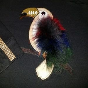 Distressed sweater with fur patch