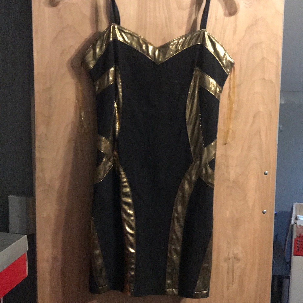 Black and gold dress with straps.