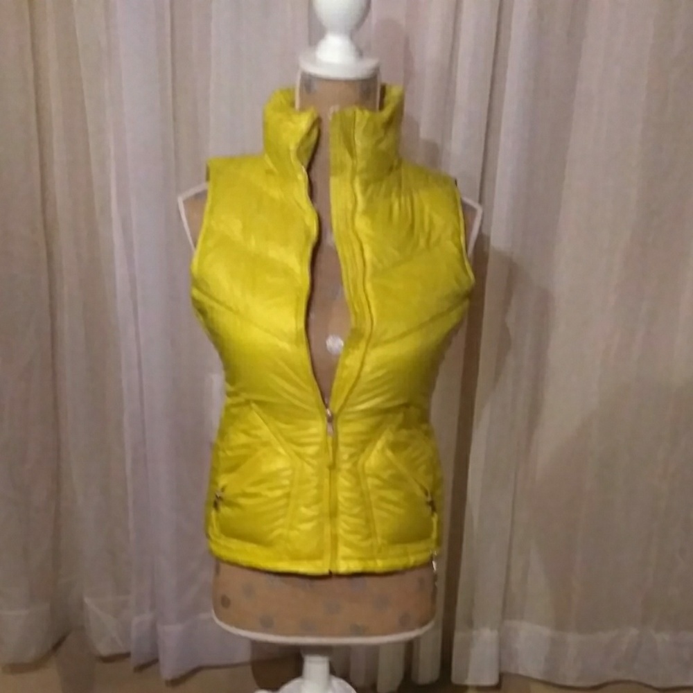 Yellow zip up puffer vest.