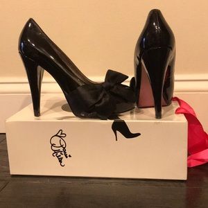 Paris Hilton black patent leather peep toe pumps.