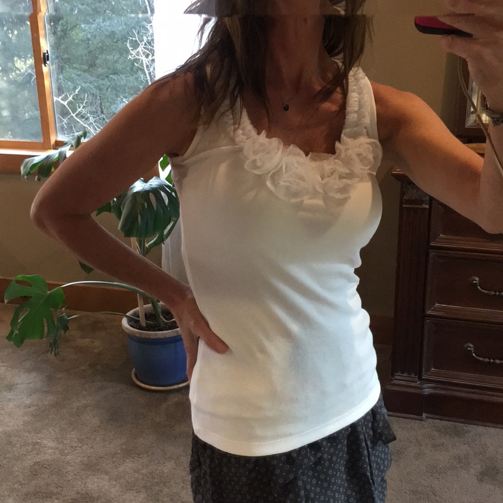 INC white sleeveless top with detail at neckline.