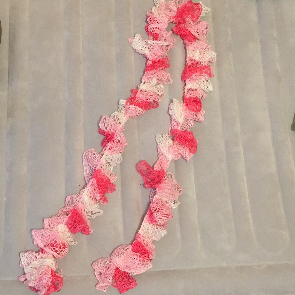 A ruffled lace pink scarf