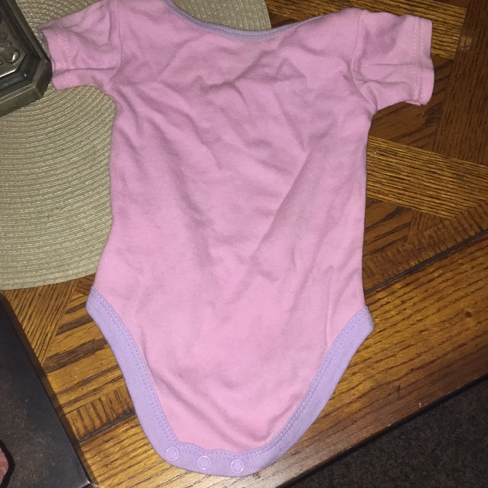 A 3-6 baby onesie thats pink yellow and  turquoise