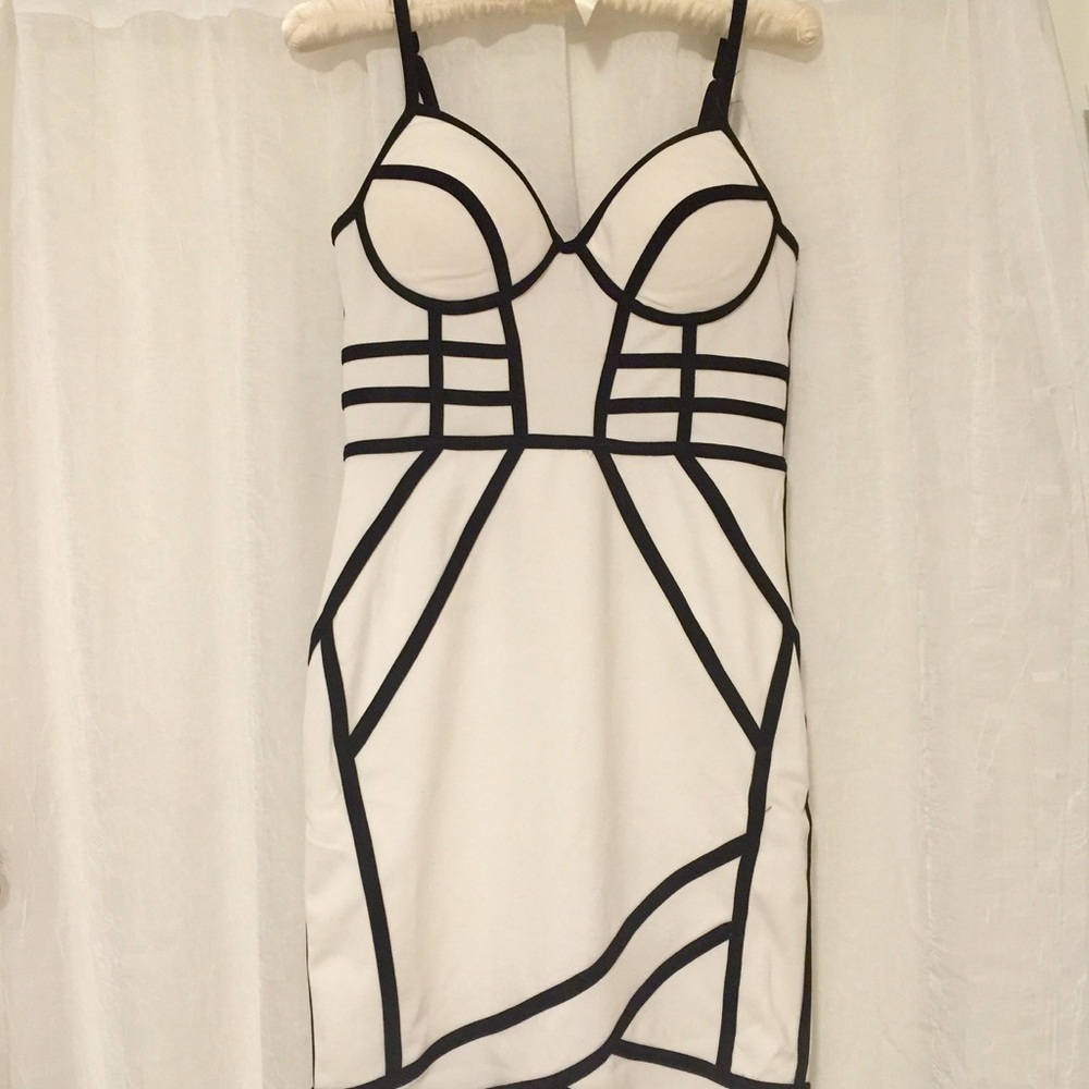 White mini dress with black geometric stripes.