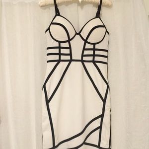 White mini dress with black geometric stripes.