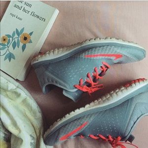 Bright coral and grey Nike sneakers
