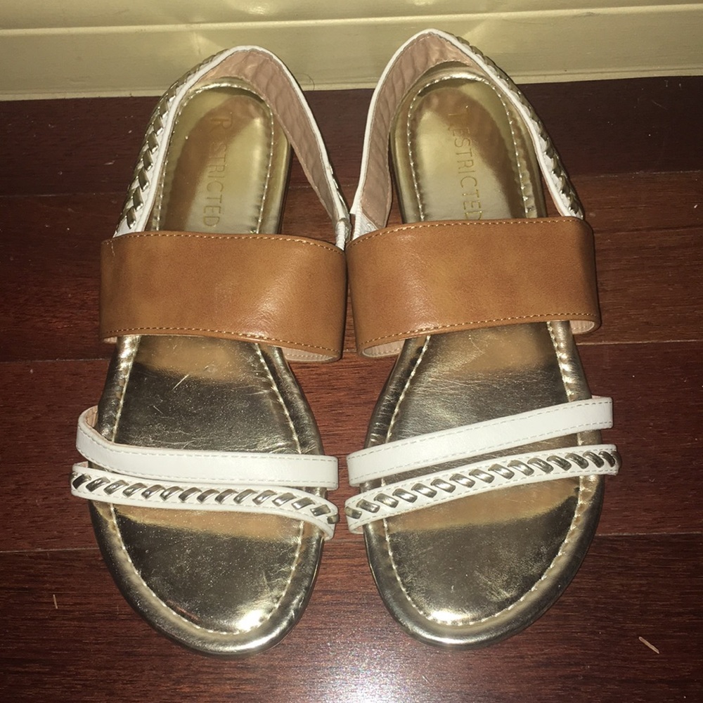 Strappy gold, white sandals.