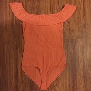 Orange body suit top.