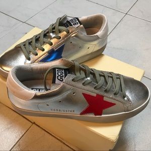 Silver / metallic tone sneakers .
