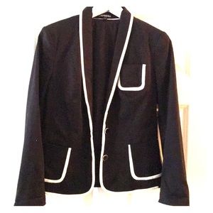 Black blazer with white piping.