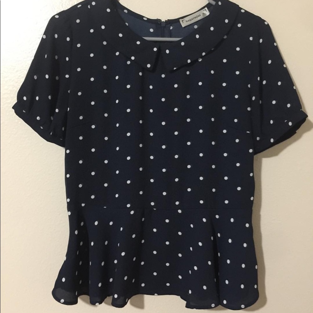 Navy blue and white polka dotted peplum top