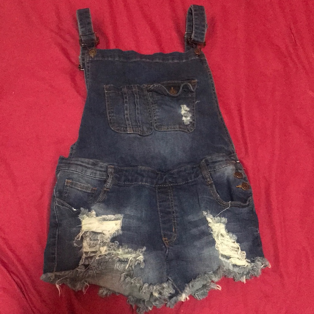 Denim, machine washed, ripped, short overalls.