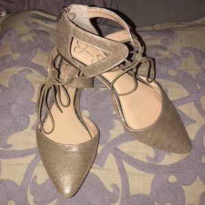 Gold pointed toe flat with zipper back and bow tie