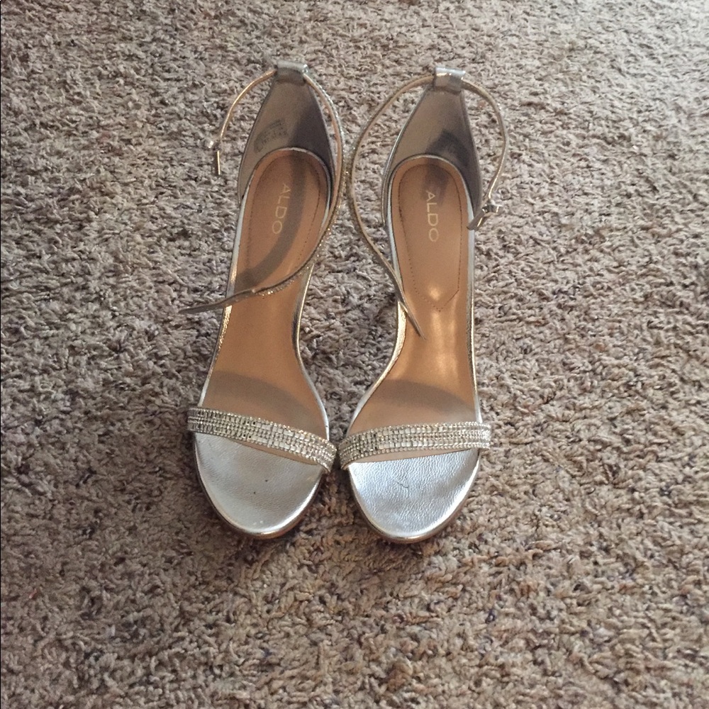 A strappy silver heel with rhinestone detailing