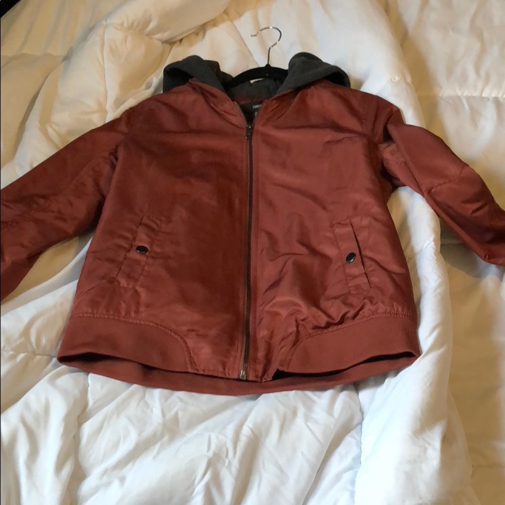 Rusty orange bomber jacket with grey hood