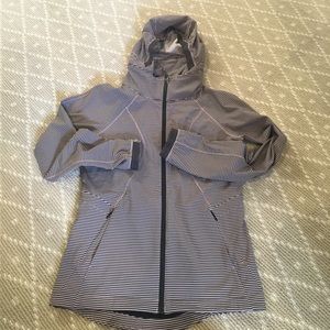 Lululemon rain jacket with self storing hood.