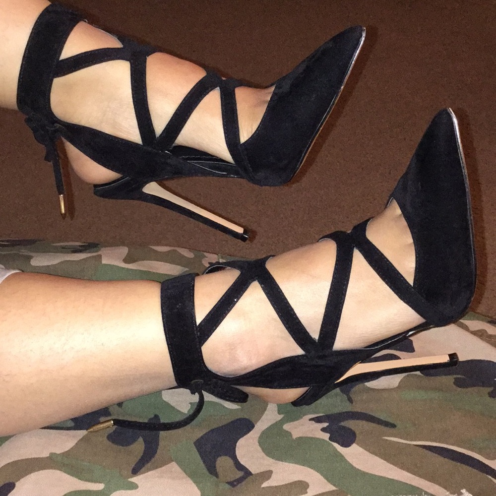 Black suede pointed toe cut-out heels.