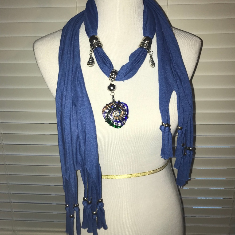 Blue scarf with beautiful colored pendant.