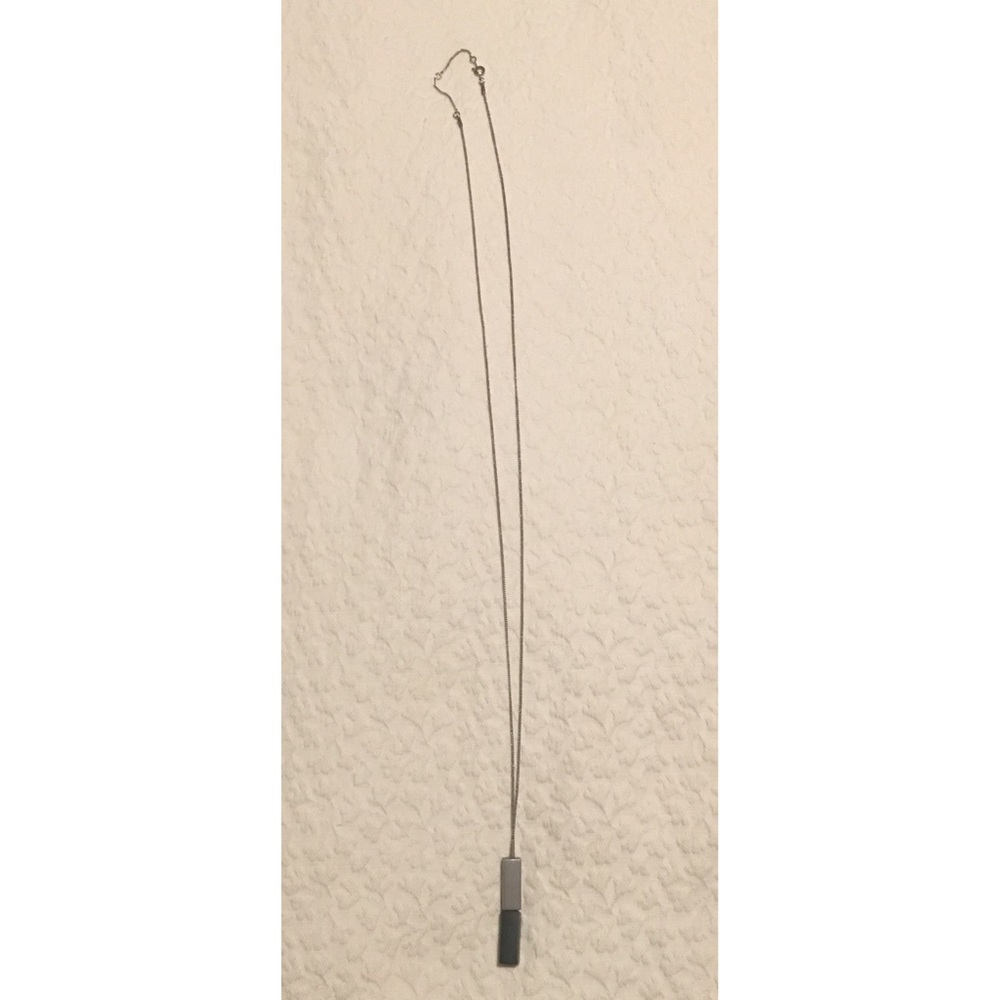 Long silver and black colored pendant necklace