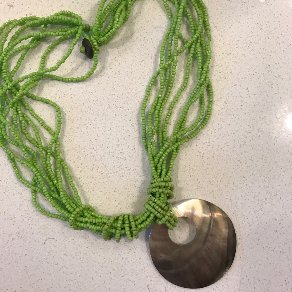 Green beaded necklace with shell pendant