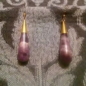 Purple gemstone goldtone earrings.