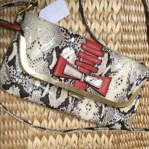 Jessica Simpson Faux snakeskin fold over clutch.