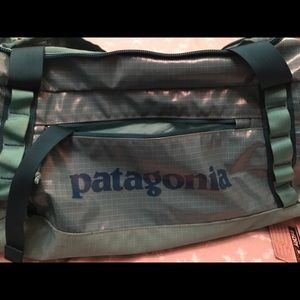 Teal 60L Patagonia duffel with straps