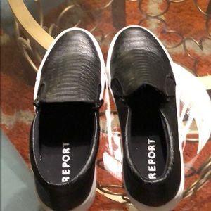 Black slip on tennis shoes.