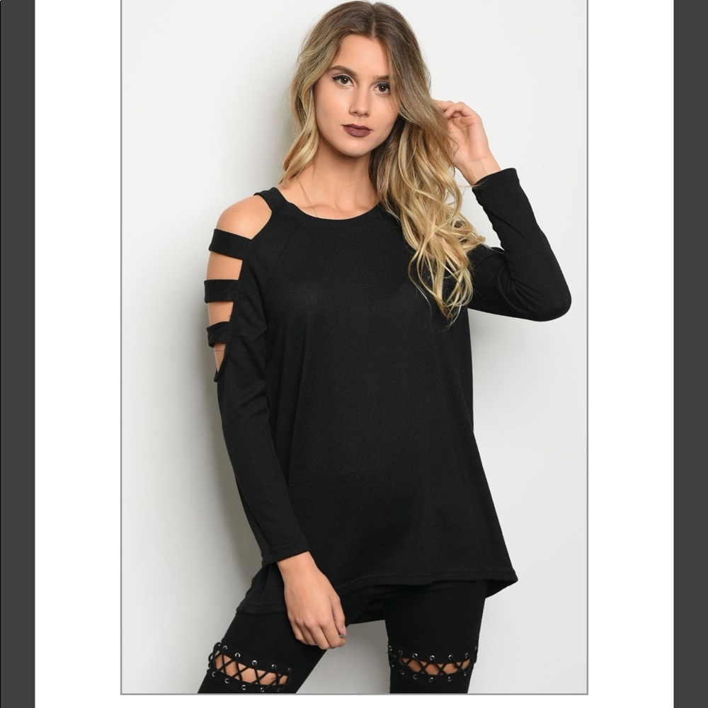 Long sleeve knit top with a sleeve cutouts.