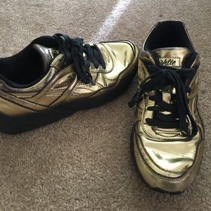 Gold Puma sneakers