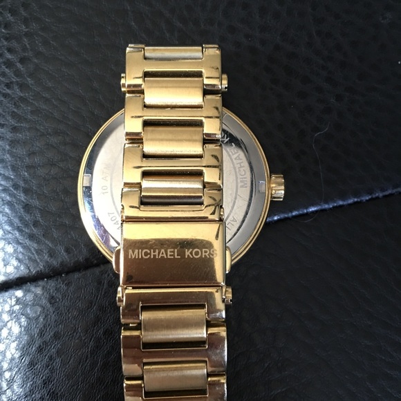Gold Michael Kors watch with a green face