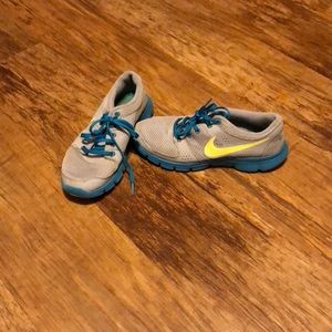 Blue and yellow Nike tennis shoes