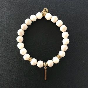 T. Jazelle riverstone with gold bar.