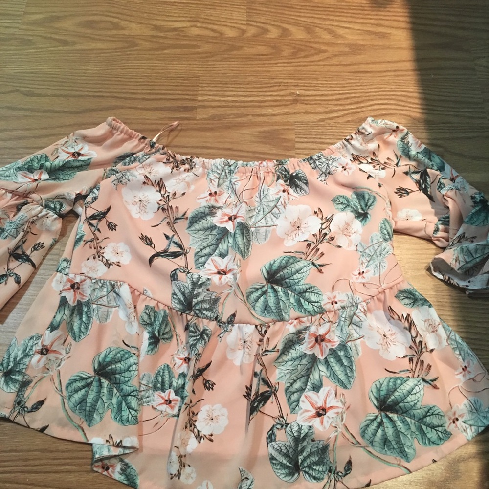 Two of the same shirts. One blue, one pink