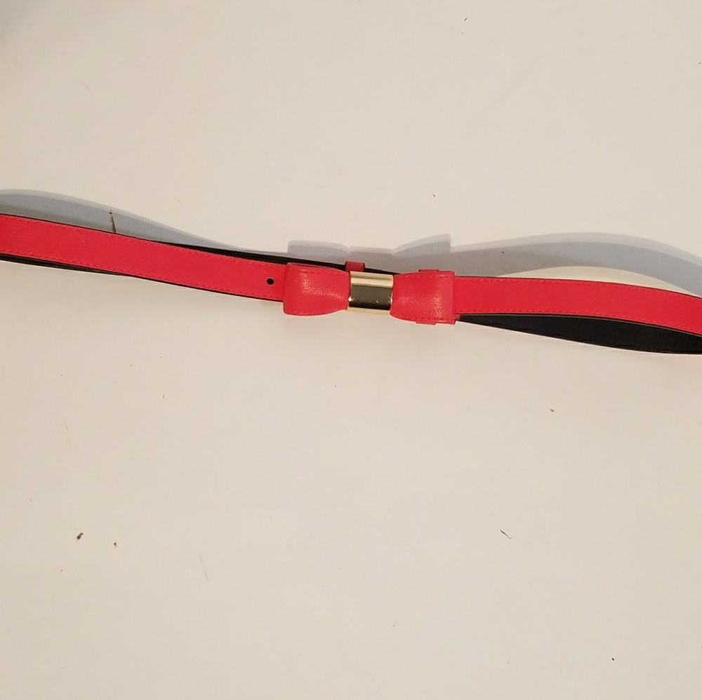 Coral belt with gold accents and bow shaped clasp