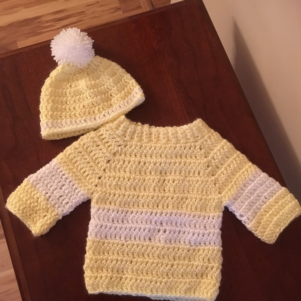 Adorable handmade sweater and hat set.