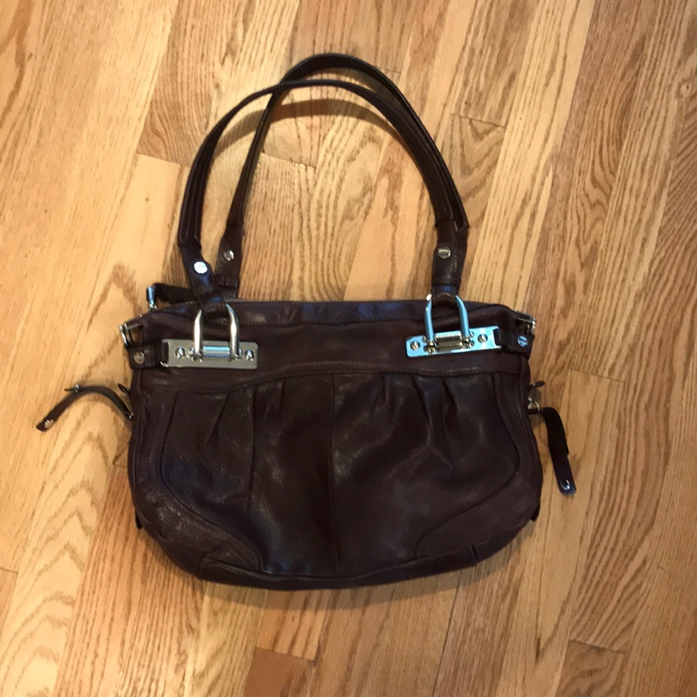 B. Makowsky purse in a brownish red color.