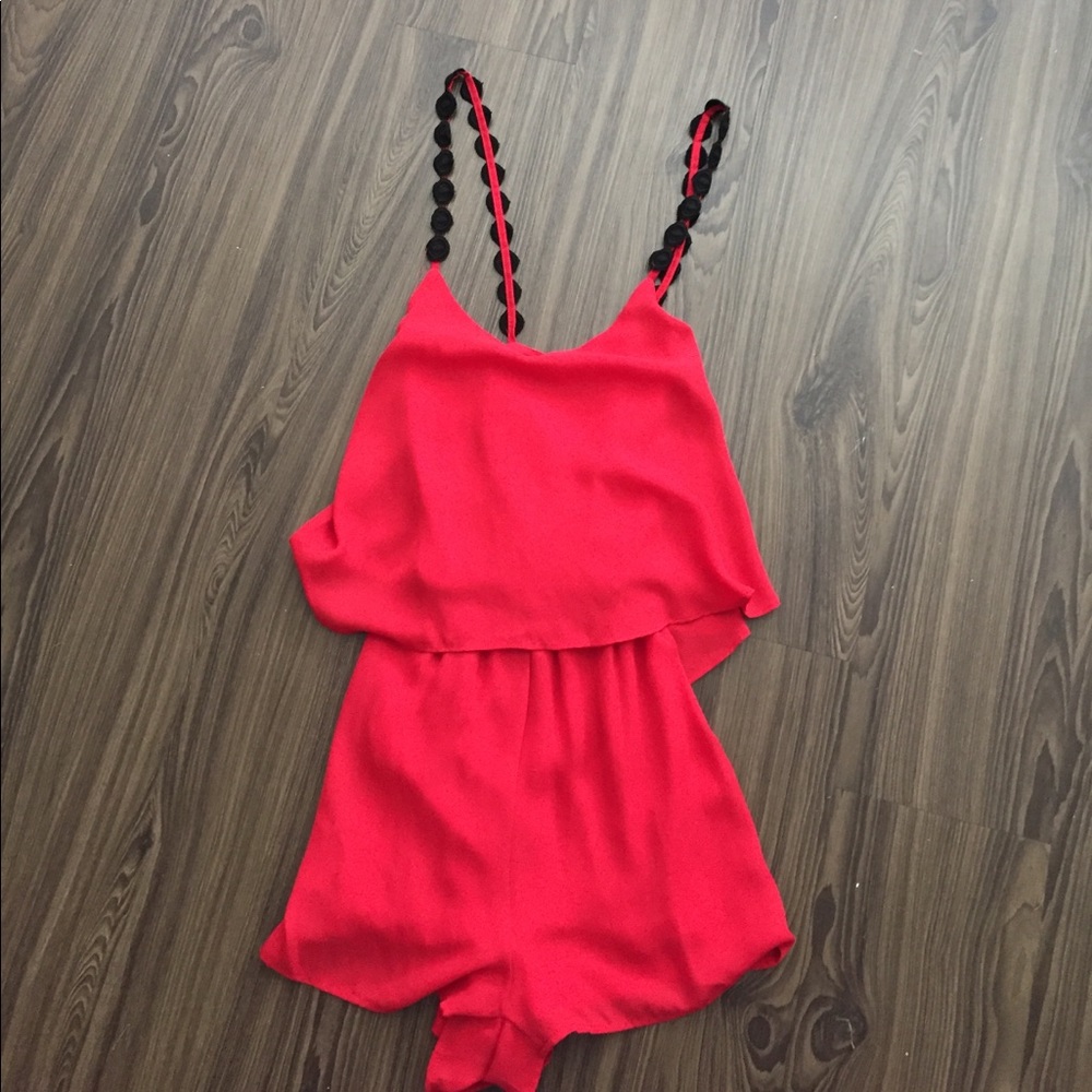 Red romper with black strap detail