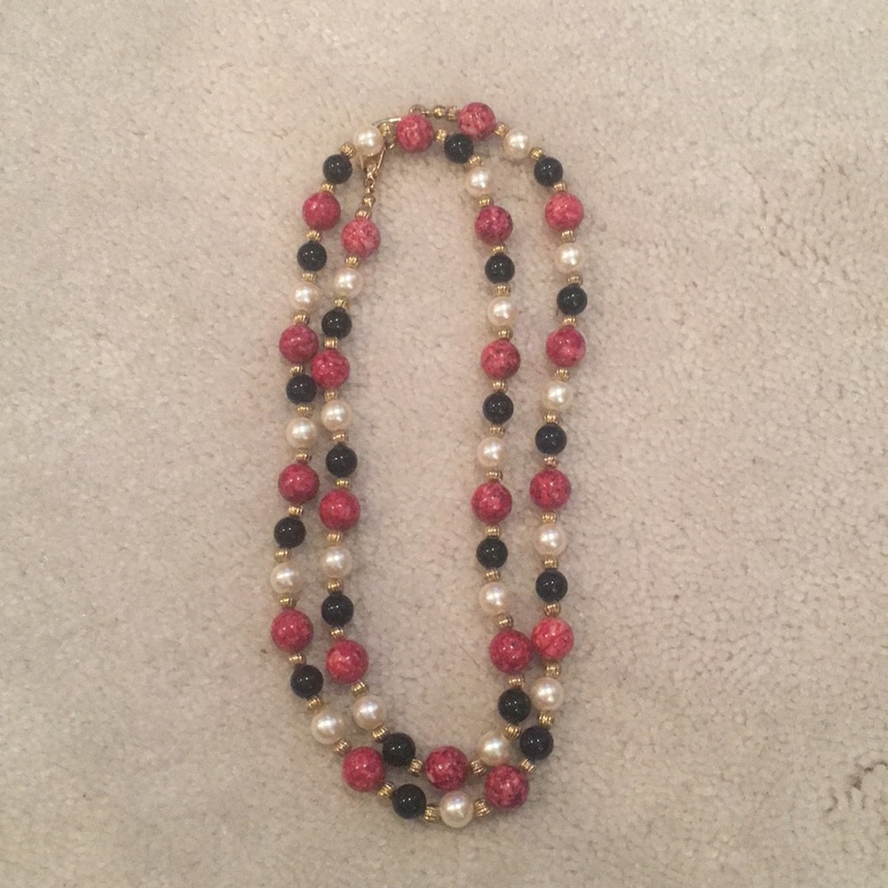Necklace in red, black, gold, and pearl beads.